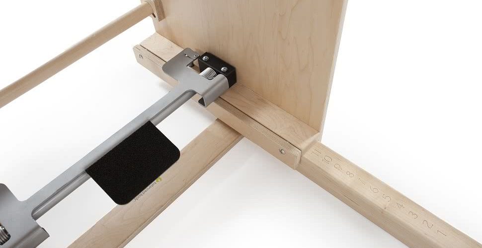 Pilates equipment with adjustable distance between barrel and ladder.