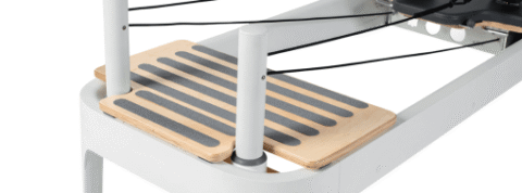 Close-up of reformer platform for enhanced Pilates workouts.