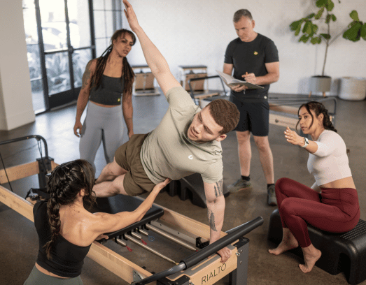 Pilates studio development with instructors and professional equipment.